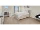 Bright bedroom with a large window, vanity area, and modern furniture, offering comfort and style at 10324 Lettuce Leaf St, Las Vegas, NV 89183