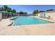 Large community pool with plenty of lounge chairs and shaded seating area at 10324 Lettuce Leaf St, Las Vegas, NV 89183