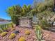 Silverado Place community sign surrounded by desert landscaping, rocks, and lush trees at 10324 Lettuce Leaf St, Las Vegas, NV 89183