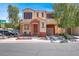 Inviting two-story home with a private garage, landscaped yard, and covered front porch at 10324 Lettuce Leaf St, Las Vegas, NV 89183