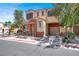 Inviting two-story home with a private garage, landscaped yard, and covered front porch at 10324 Lettuce Leaf St, Las Vegas, NV 89183