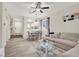 Open-concept living area featuring a dining table, kitchen view, and comfortable seating at 10324 Lettuce Leaf St, Las Vegas, NV 89183