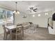 Open-concept living room with dining area featuring a ceiling fan and lots of natural light at 10324 Lettuce Leaf St, Las Vegas, NV 89183