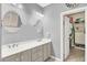 Elegant bathroom features double sinks and a walk-in closet for ample storage and convenience at 10385 Kern Ridge St, Las Vegas, NV 89178