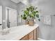 Bathroom vanity with double sinks, large mirror, decor, and plants adds a fresh touch to the space at 10385 Kern Ridge St, Las Vegas, NV 89178