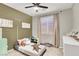 Cozy bedroom with neutral carpet and a ceiling fan at 10385 Kern Ridge St, Las Vegas, NV 89178