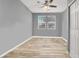 Bright and airy bedroom with wood floors, large windows, and neutral wall paint at 10385 Kern Ridge St, Las Vegas, NV 89178