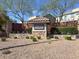 Community entrance sign, featuring stone and brick construction with tiled roof and well-manicured landscaping at 10385 Kern Ridge St, Las Vegas, NV 89178