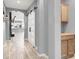 Bright hallway with modern wood-look floors, barn door, and convenient storage cabinets, enhancing the home's functionality at 10385 Kern Ridge St, Las Vegas, NV 89178