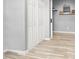 Hallway with wood floors and modern sliding doors with a stylish mirror and shelf at 10385 Kern Ridge St, Las Vegas, NV 89178