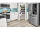 Modern kitchen with stainless steel appliances and a pantry behind the door offers plenty of space at 10385 Kern Ridge St, Las Vegas, NV 89178