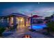 Inviting backyard with a sparkling pool, patio, and a cozy fire pit area, perfect for outdoor relaxation and entertaining at 10385 Kern Ridge St, Las Vegas, NV 89178