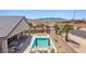 Backyard featuring a pool, desert landscaping, covered patio, and views of the surrounding area at 1357 Manassas Rdg Rdg, Mesquite, NV 89027