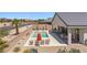 Home featuring a backyard pool, desert landscaping, covered patio with outdoor seating, and mountain views at 1357 Manassas Rdg Rdg, Mesquite, NV 89027