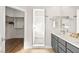 Modern bathroom with white tiled shower, walk-in closet, gray cabinets, and double mirrors offering plenty of space at 1357 Manassas Rdg Rdg, Mesquite, NV 89027