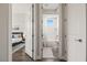 Clean, white-tiled bathroom with modern fixtures and a bright window, adjacent to bedroom at 1357 Manassas Rdg Rdg, Mesquite, NV 89027