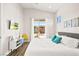 Comfortable bedroom with plush bedding, a TV, backyard views, and a stylish accent chair at 1357 Manassas Rdg Rdg, Mesquite, NV 89027