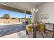 Dining area with sliding glass doors offers views of the lush backyard and sparkling swimming pool at 1357 Manassas Rdg Rdg, Mesquite, NV 89027