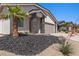 Well-manicured front yard featuring desert landscaping with a mature palm tree and rock detail leading up to the front door at 1357 Manassas Rdg Rdg, Mesquite, NV 89027