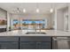 Kitchen island features a stainless steel sink and view of the living space and backyard at 1357 Manassas Rdg Rdg, Mesquite, NV 89027
