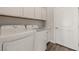 Efficient laundry room with modern washer and dryer units, ample storage, and a clean, organized design at 1357 Manassas Rdg Rdg, Mesquite, NV 89027