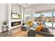 Comfortable living room featuring an electric fireplace, large windows with backyard views, and stylish furniture at 1357 Manassas Rdg Rdg, Mesquite, NV 89027