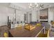 Open-concept living space boasts a modern kitchen with stainless steel appliances and a dining area with yellow chairs at 1357 Manassas Rdg Rdg, Mesquite, NV 89027