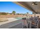 Outdoor patio area showcasing a sparkling pool, comfortable lounge chairs, and colorful dining set at 1357 Manassas Rdg Rdg, Mesquite, NV 89027