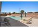 Inviting backyard pool featuring lounge chairs and umbrellas for a relaxing outdoor experience at 1357 Manassas Rdg Rdg, Mesquite, NV 89027