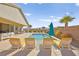 Inviting backyard pool with lounge chairs and desert landscaping offers the perfect spot for relaxation at 1357 Manassas Rdg Rdg, Mesquite, NV 89027