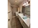 Bathroom with a walk-in shower, modern vanity, framed mirror, and stylish tile flooring at 1370 Vegas Valley Dr # 47, Las Vegas, NV 89169