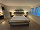 Bedroom with wood flooring, queen bed, lamps, decor and window with blinds at 1370 Vegas Valley Dr # 47, Las Vegas, NV 89169