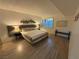 Bedroom with wood flooring, window with blinds, and a queen bed with lamps at 1370 Vegas Valley Dr # 47, Las Vegas, NV 89169