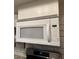 White microwave appliance above a stainless steel oven and cooktop at 1370 Vegas Valley Dr # 47, Las Vegas, NV 89169