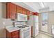 Bright kitchen with white appliances, wood cabinets, and functional layout at 1405 Vegas Valley Dr # 257, Las Vegas, NV 89169