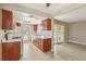 Well-lit kitchen showcasing wood cabinets and white appliances, seamlessly connected to a dining area and a sliding door at 1405 Vegas Valley Dr # 257, Las Vegas, NV 89169