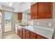 Kitchen view of wood cabinetry and white countertops, complemented by natural light and a tile backsplash at 1405 Vegas Valley Dr # 257, Las Vegas, NV 89169