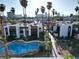 Above angle view of the community pool and the apartment buildings with palm trees and city views at 1405 Vegas Valley Dr # 257, Las Vegas, NV 89169