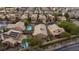 Aerial view of a home with a private pool and spa, complimented by lush landscaping in a desert community at 19 Dryden Park Ave, Las Vegas, NV 89148