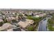Aerial view of a neighborhood showcasing homes with desert landscaping, tile roofs, and community streets at 19 Dryden Park Ave, Las Vegas, NV 89148
