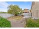 Spacious backyard with gravel, minimal landscaping, mature tree and privacy wall at 19 Dryden Park Ave, Las Vegas, NV 89148