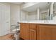 Bright bathroom featuring a double vanity with wood cabinets and a large mirror at 19 Dryden Park Ave, Las Vegas, NV 89148
