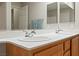 Bathroom featuring a large vanity with double sinks, mirrors, and lighting fixtures at 19 Dryden Park Ave, Las Vegas, NV 89148