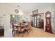 The dining room features a chandelier, wood floors, and sliding glass doors to the backyard at 19 Dryden Park Ave, Las Vegas, NV 89148
