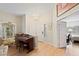 The entryway features wood floors, a chandelier, and views to a bedroom and living area at 19 Dryden Park Ave, Las Vegas, NV 89148