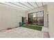 Enclosed outdoor patio featuring faux grass and ample seating space at 19 Dryden Park Ave, Las Vegas, NV 89148