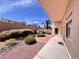 Landscaped backyard featuring decorative rocks, plants, and a private patio at 1963 Dakota Lodge Ave, Las Vegas, NV 89123