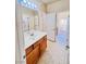 Bright bathroom featuring a vanity with cabinet storage, and a large, well-lit mirror at 1963 Dakota Lodge Ave, Las Vegas, NV 89123