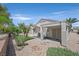 A charming backyard with a covered patio, desert landscaping, and views of the surrounding greenery at 1991 High Mesa Dr, Henderson, NV 89012