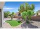 A serene backyard featuring desert landscaping, mature trees, and a small putting green at 1991 High Mesa Dr, Henderson, NV 89012